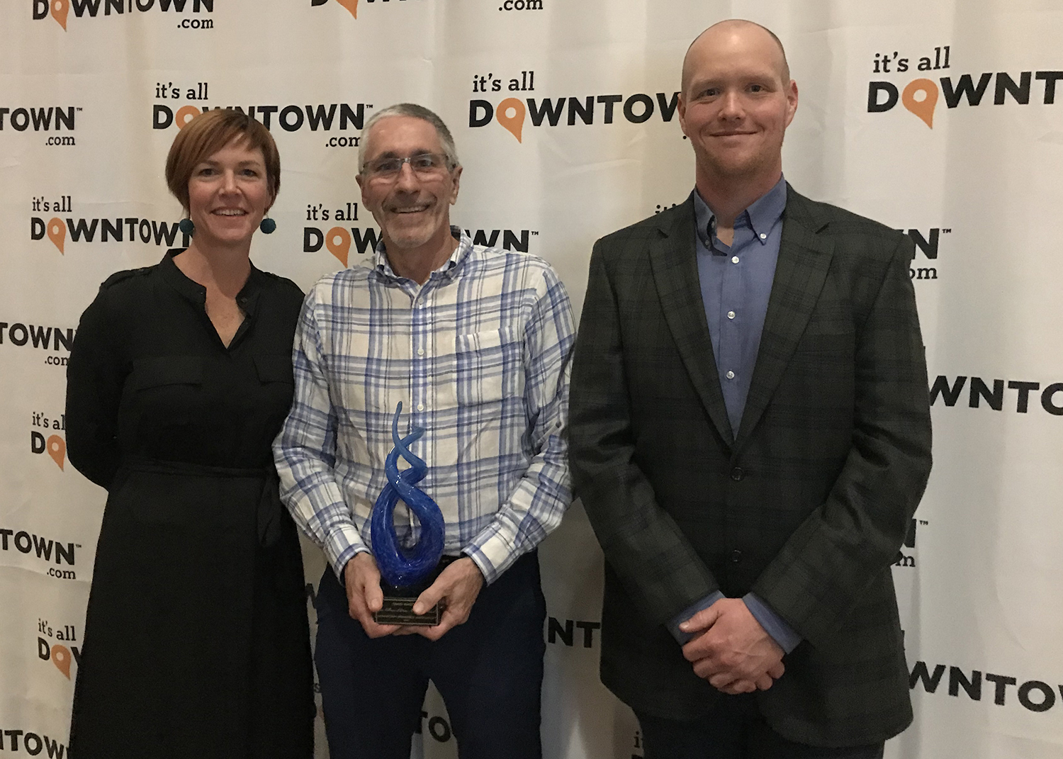 Craig Wagoner poses with his Tom Billionis lifetime achievement award, standing between Michelle Billionis and Vance Hall.
