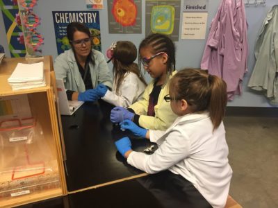 Children do a science experiment at the Discovery Center