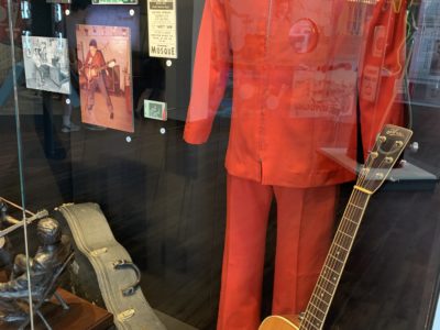 A red jumpsuit worn by Elvis Presley and an acoustic guitar on display at History Museum on the Square