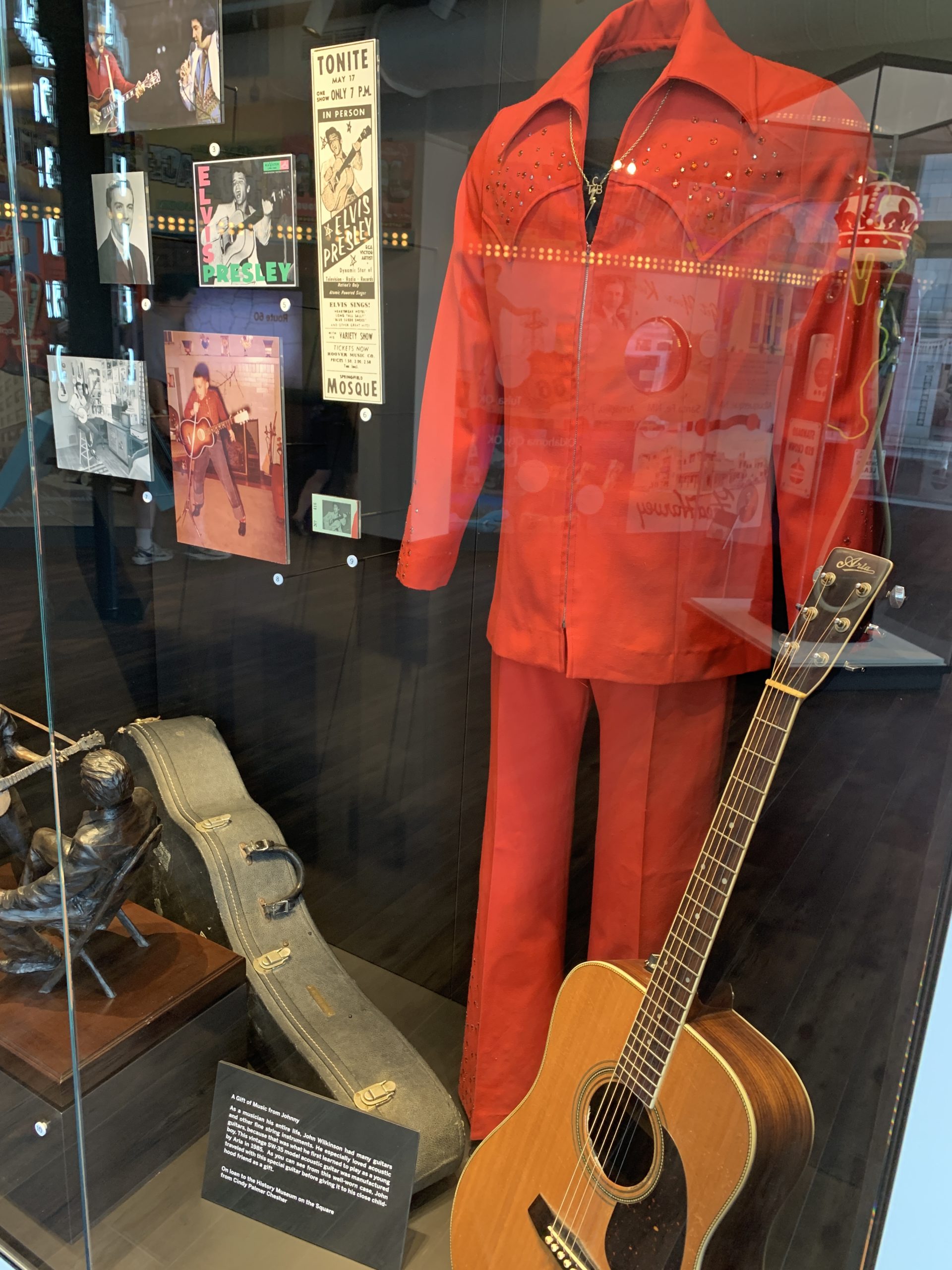 A red jumpsuit worn by Elvis Presley and an acoustic guitar on display at History Museum on the Square