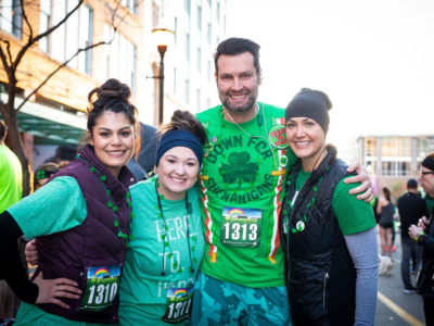 A man and three women pose for a photo at the ShamRox 5K