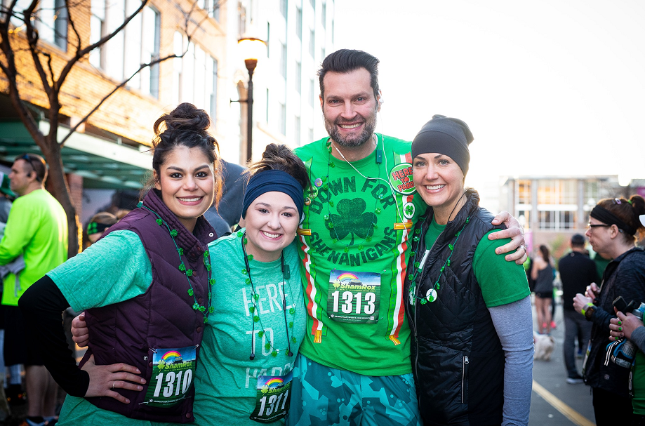 A man and three women pose for a photo at the ShamRox 5K